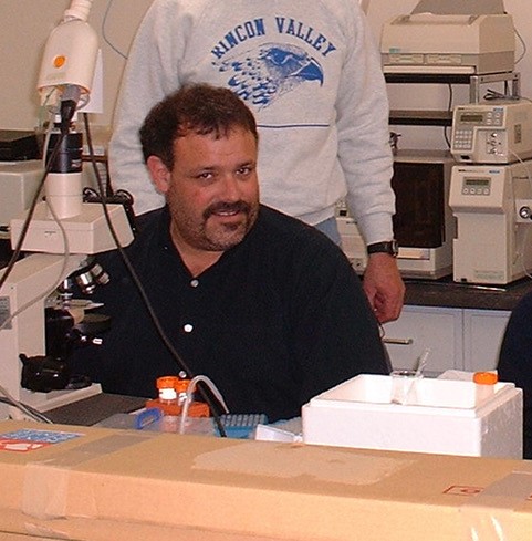 Gary Cherr sits at a work bench