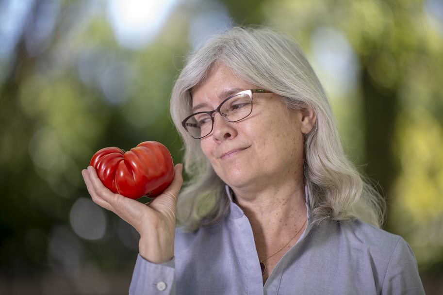 Anne Britt poses with a tomato
