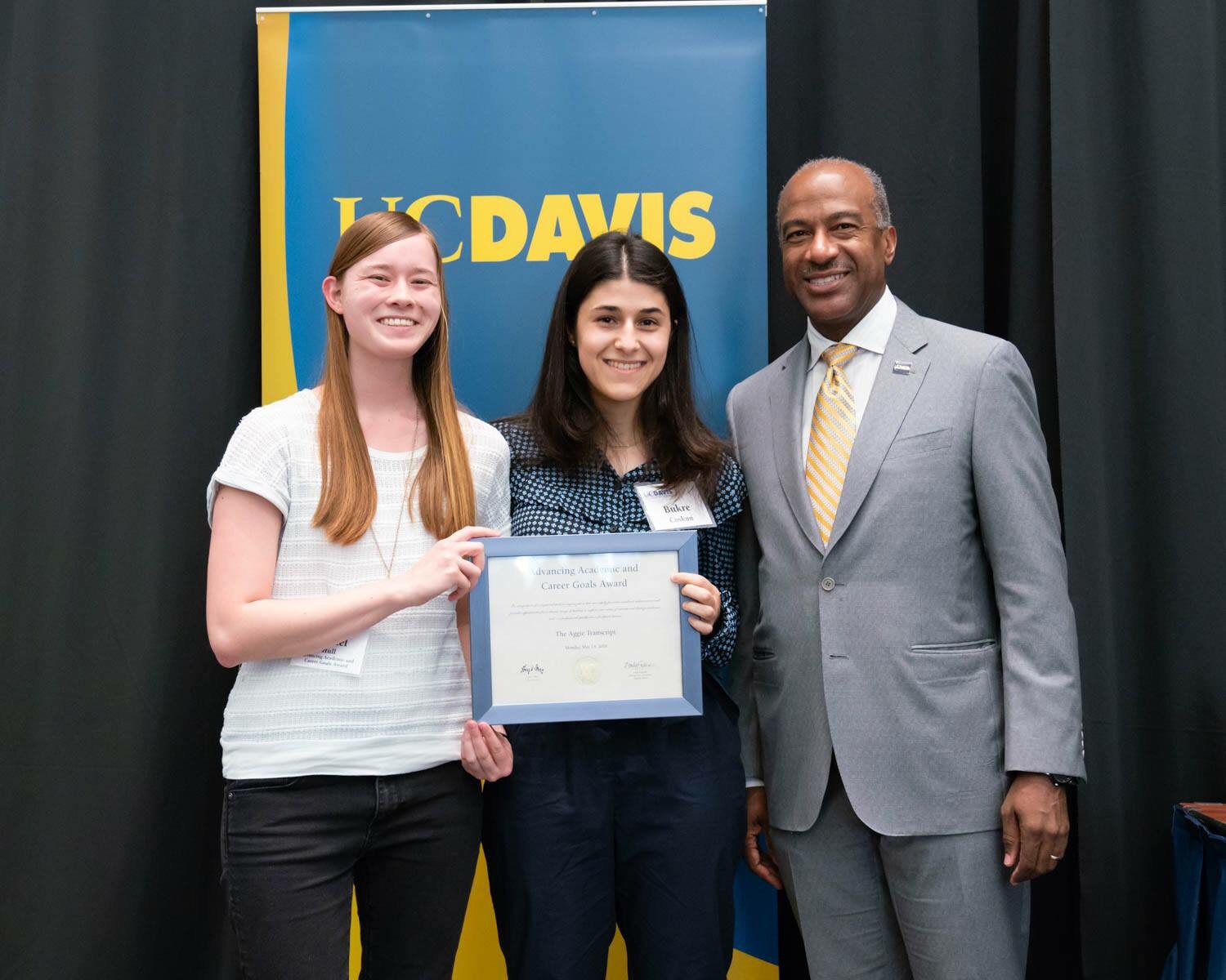 The Aggie Transcript editors Rachel Hull and Bukre Coskun stand with UC Davis Chancellor Gary May after receiving the UC Davis Advancing Academic and Career Goals Award. Courtesy photo. 
