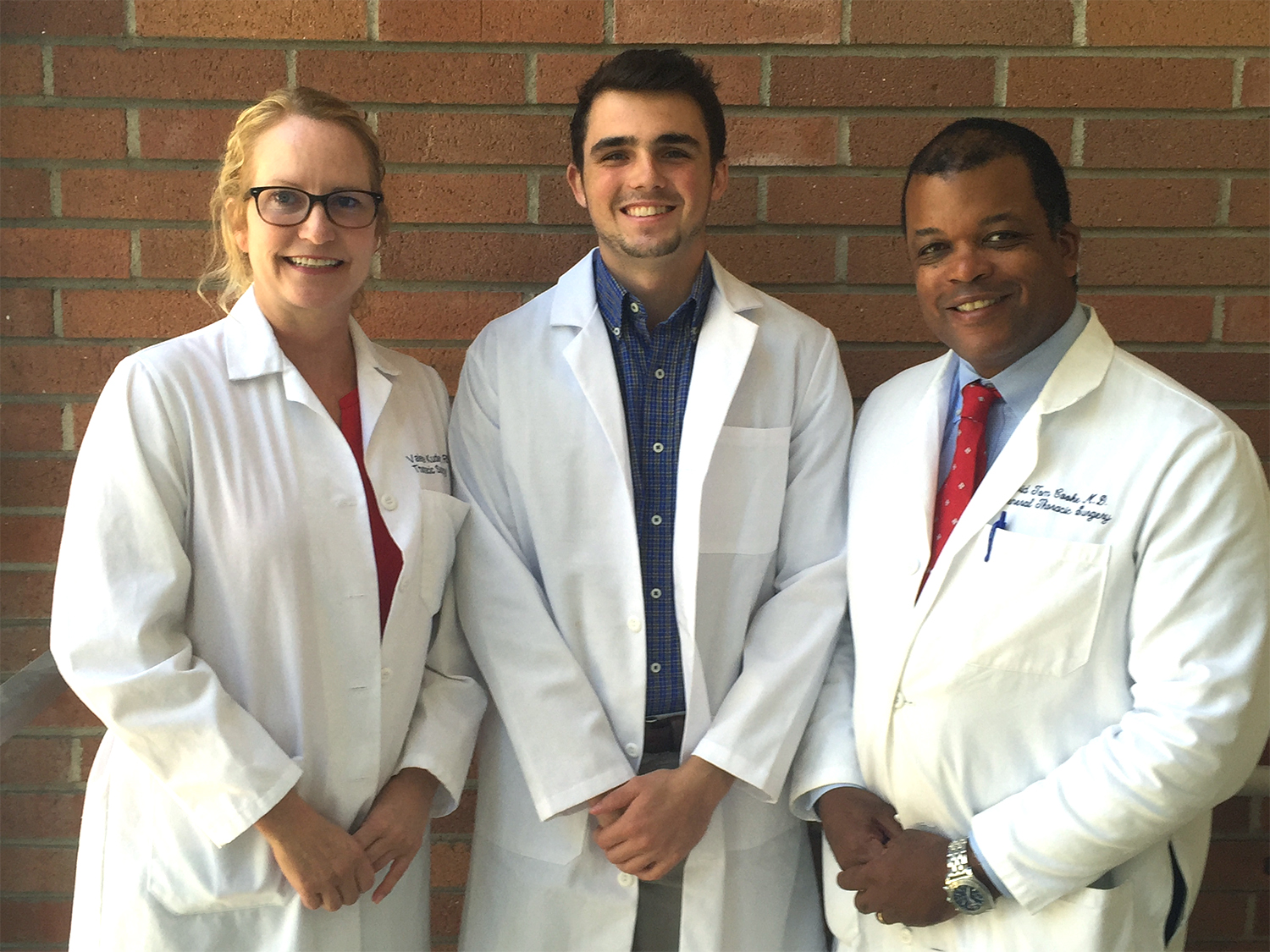 Connor Grant (middle) stands with a couple of his mentors from UC Davis Health.