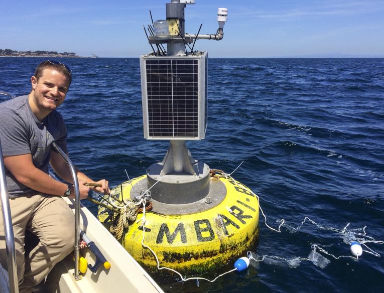 UC Davis graduate student Matthew Savoca sits beside a research buoy as part of his marine plastic research into why seabirds eat plastic. Photo: Courtesy Matthew Savoca