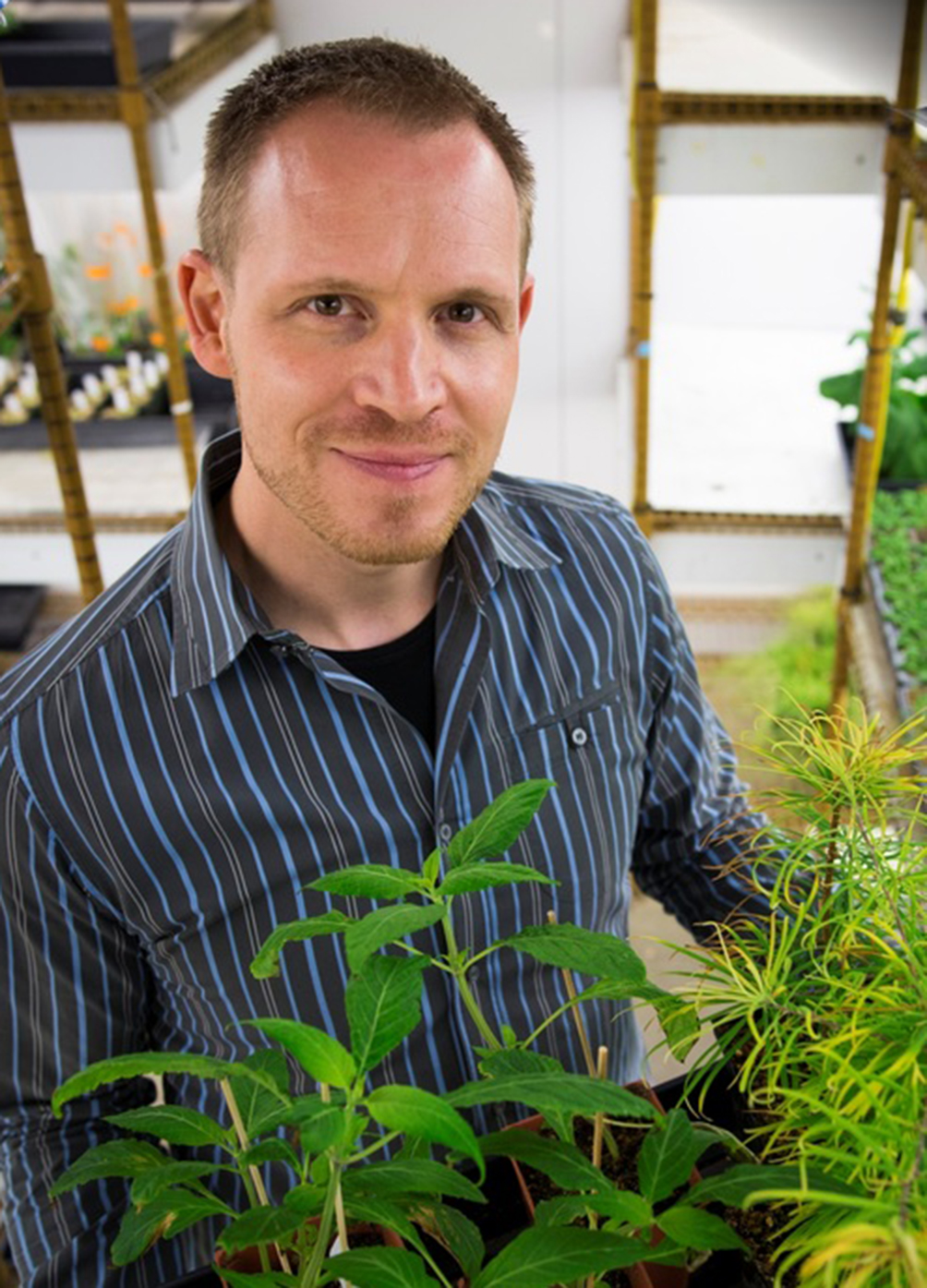 Philipp Zerbe stands with plants