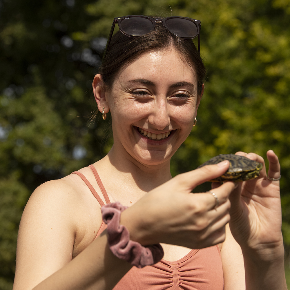 Young woman holding a turtle