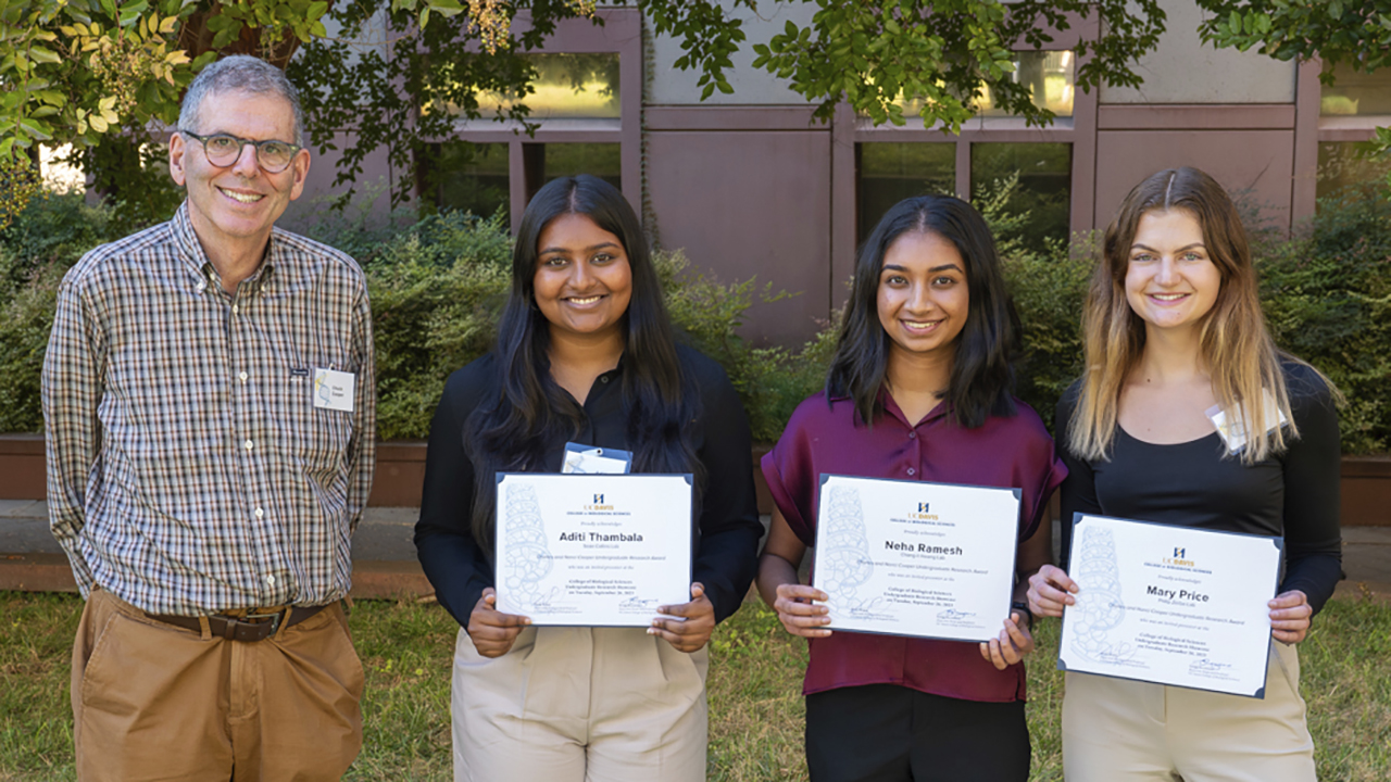 Charles Cooper stands next to three students who were recipients of an undergraduate research award funded by him and his wife, Nancy.  