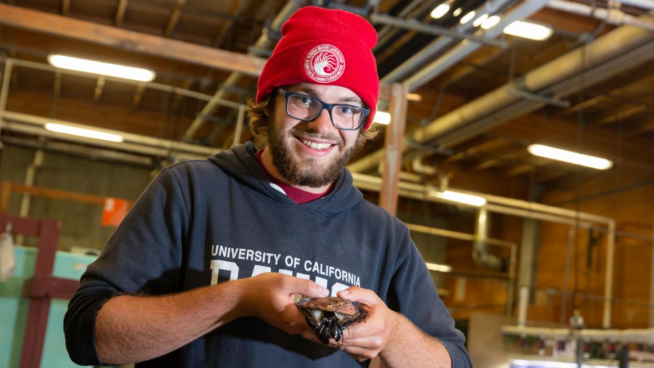 Evan Tjeerdema holds a red abalone