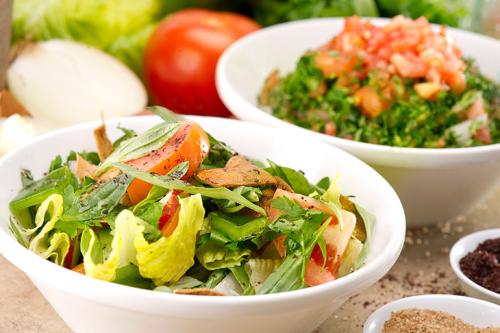 Healthy foods and greens in a white bowl