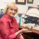 Ann Hedrick holds up a cricket statue in her office. David Slipher/UC Davis