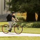 Student on bicycle wearing mask