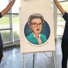 Two students unveiling a caricature of Barbara Horwitz