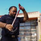 Abiel Malepeai, who received the UC President's Award for Outstanding Student Leadership for his advocacy for Pacific Islanders, shows off the cane of his fraternity outside the UC Davis Fire Department, where he serves as a student EMT.