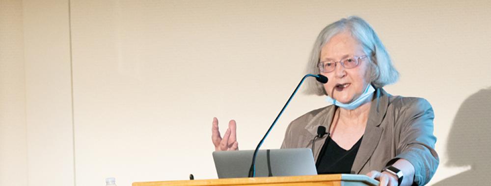 Woman at the podium speaking to a crowd