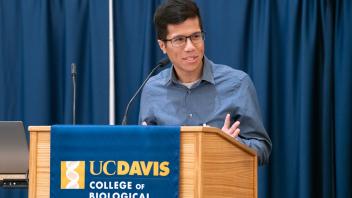 Male student speaking at podium. 