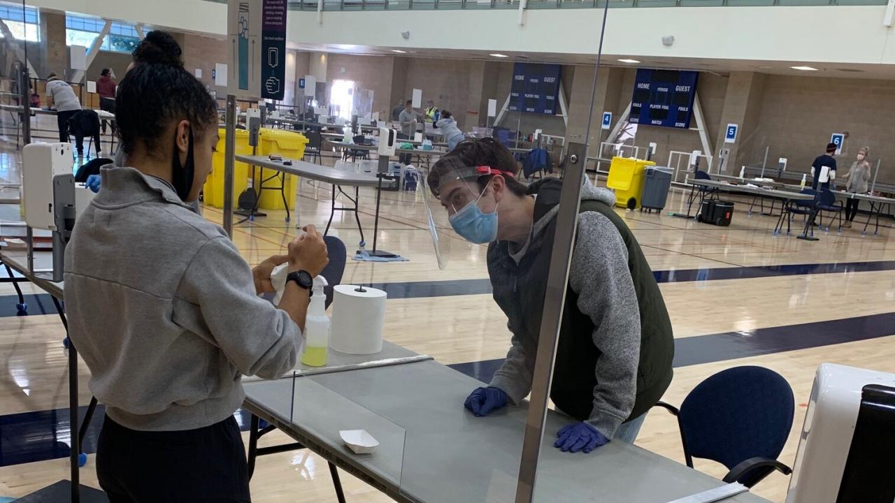 Ella Lewis and Connor Murphy, both students enrolled in the “Mass Testing for COVID-19” at UC Davis, prepare to test students for the virus at the Activities and Recreation Center. Minh Hahn/Enterprise Courtesy photo Two students stand in the ARC
