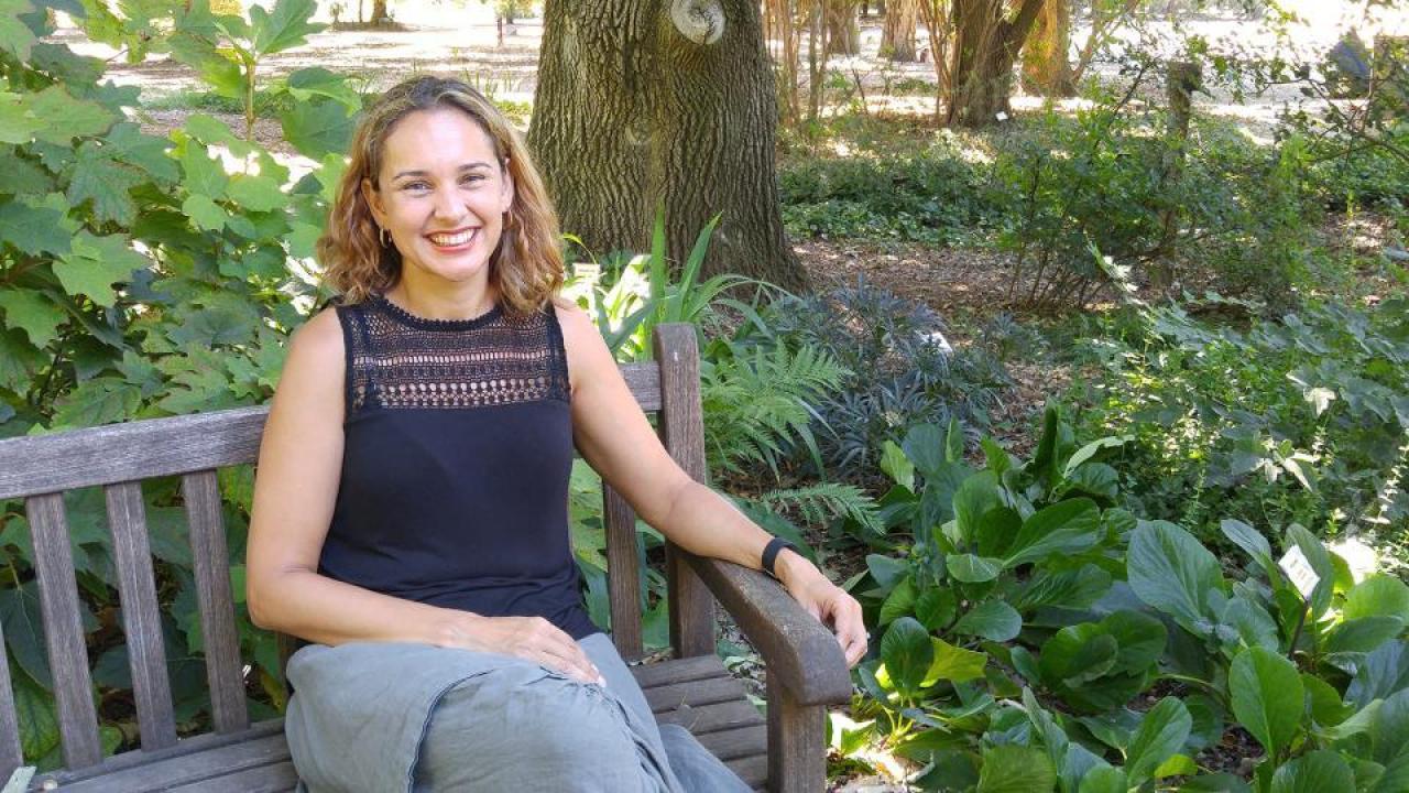 Siobhan Brady, associate professor of plant biology in the College of Biological Sciences, is among 19 UC Davis researchers whose “highly cited” work has been identified as amongst the most influential in their fields in an annual survey Siobhan Brady sits outside.