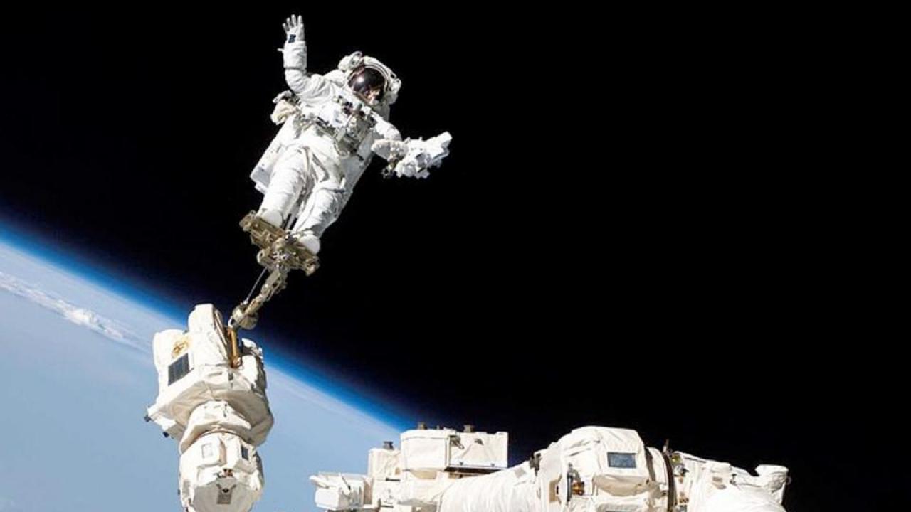 Astronaut Stephen K. Robinson, STS-114 mission specialist, anchored to a foot restraint on the extended International Space Station’s Canadarm2, participates in the mission's third session of extravehicular activity. The blackness of space and Earth’s horizon form the backdrop for the image. Photo taken Aug. 3, 2005. Robinson is a UC Davis graduate who returned to teach in 2012. He now serves as chair of the UC Davis Department of Mechanical and Aerospace Engineering. He flew on four space shuttle missions. (Photo/NASA) Astronaut Stephen K. Robinson, STS-114 mission specialist, anchored to a foot restraint on the extended International Space Station’s Canadarm2, participates in the mission's third session of extravehicular activity