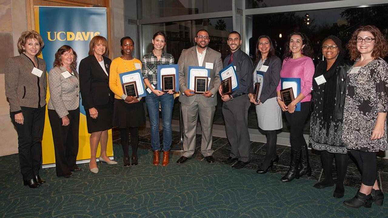 UC Davis’ new CAMPOS Faculty Scholars (holding certificates and plaques), from left, Maureen Njoki Kinyua, Rebecca Hernandez, Jesús M. Velázquez, Samuel Díaz-Muñoz, Jeanette Ruiz and Verónica Martínez-Cerdeño. They are flanked by, from far left, Linda P.B. Katehi, chancellor emerita and UC Davis ADVANCE principal investigator; Karen McDonald, faculty director and co-principal investigator; and Mary Lou de Leon Siantz, CAMPOS founding director; and, at far right, 2015 CAMPOS Faculty Scholars Alexis Patterson