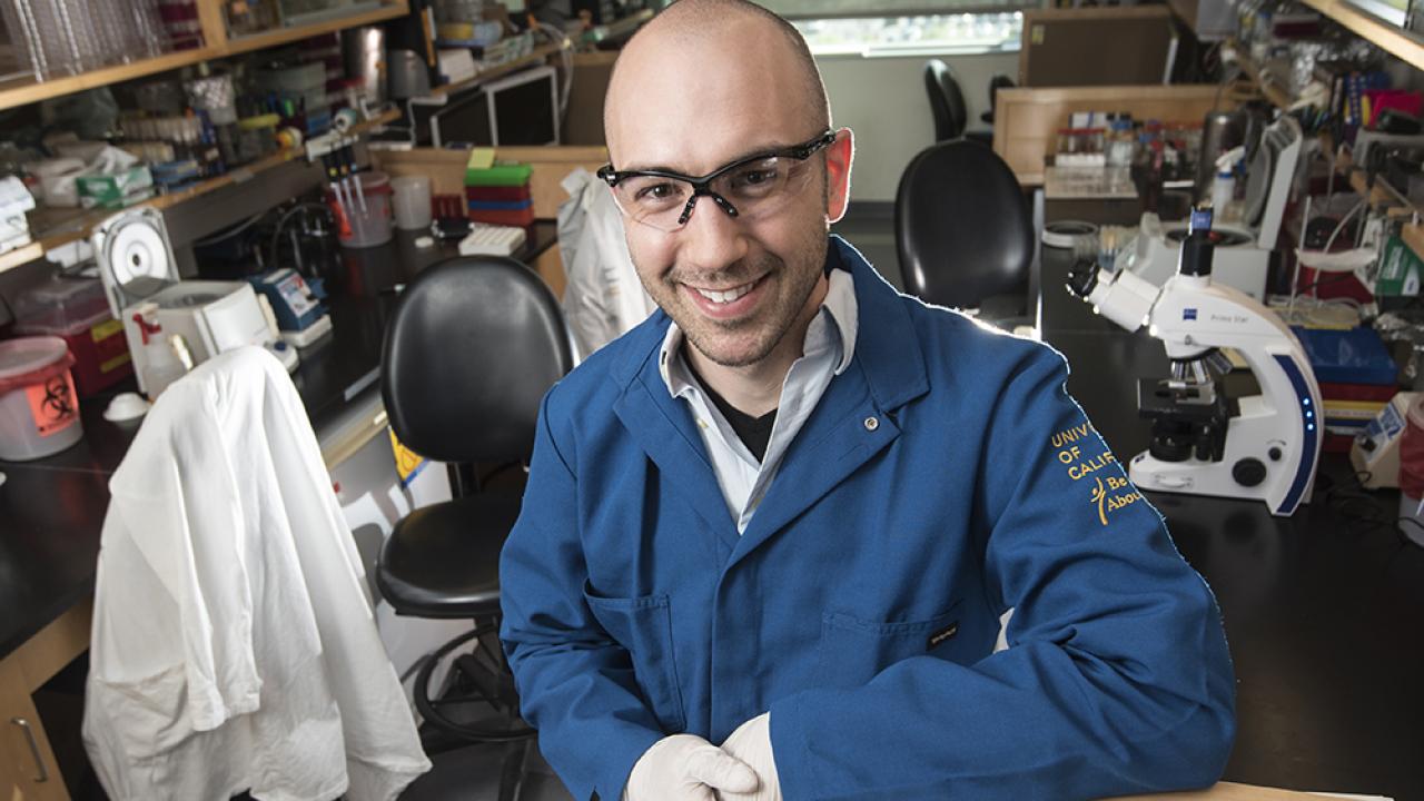Male student in lab smiling