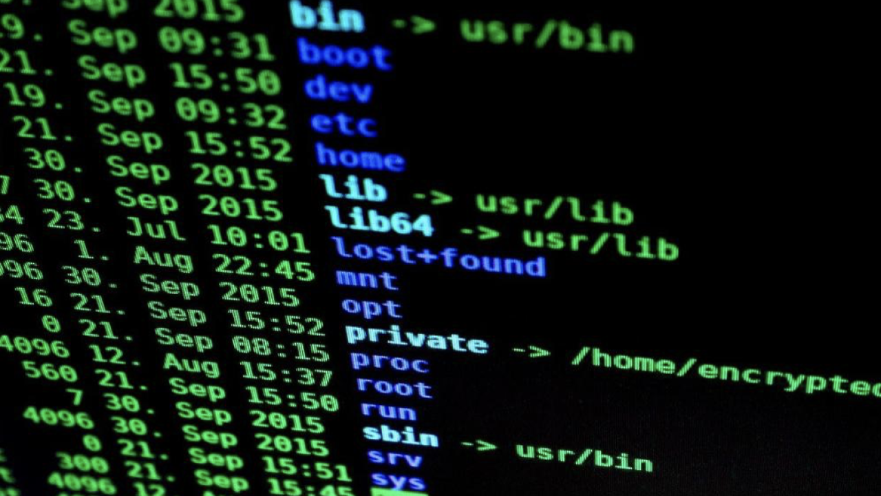 Black screen of monitor with blue and green text on it displaying a CLI