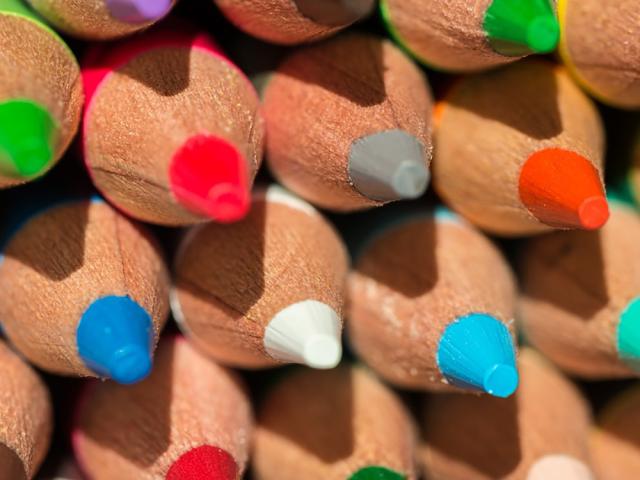 A mix of colored pencils stacked together