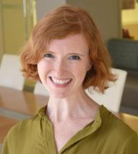 A person with orange-blond hair in a green shirt