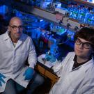 Professor Ken Kaplan and student Mackenzie Noon sit in the lab