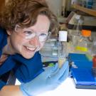 Kassandra Ori-McKenney glances at a vial filled with flies. David Slipher/UC Davis 