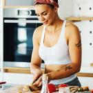 Athletic women in kitchen preparig food