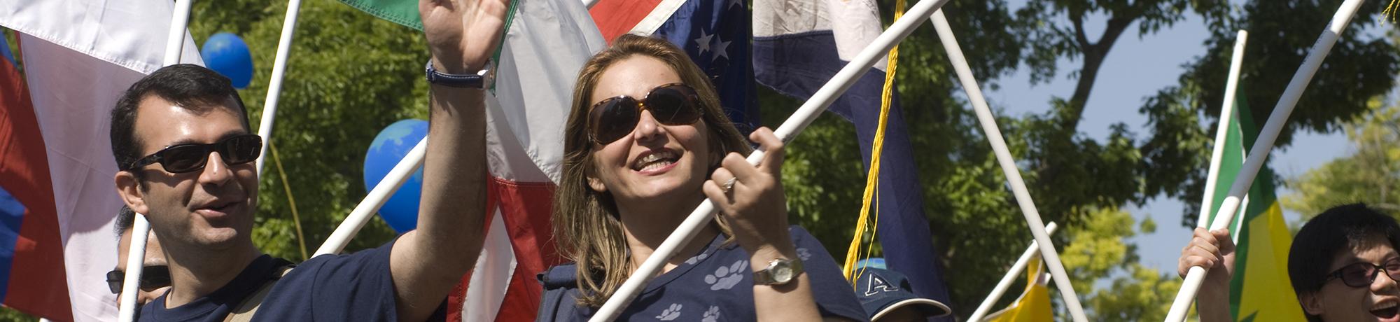 Man and woman holding flags during a parade